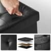 Sort foldbar ottoman med blødt læderlook og opbevaringsrum.