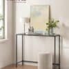Elegant indgangskonsol med hærdet glas og moderne design.